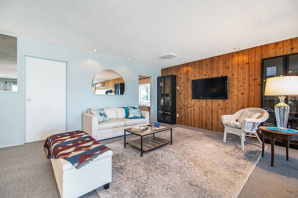 The Whale House living room with TV and cedar accent wall